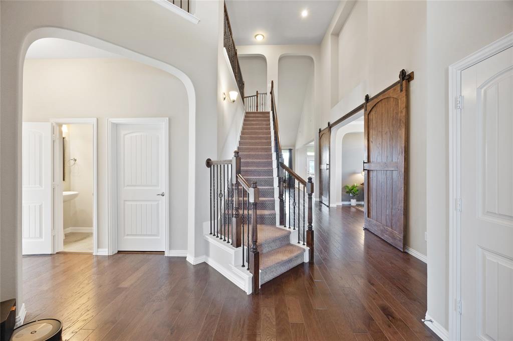 216 Equestrian Road Hickory Creek, TX 75065 - Photo 3 of 26 a view of a hallway with wooden floor and stairs