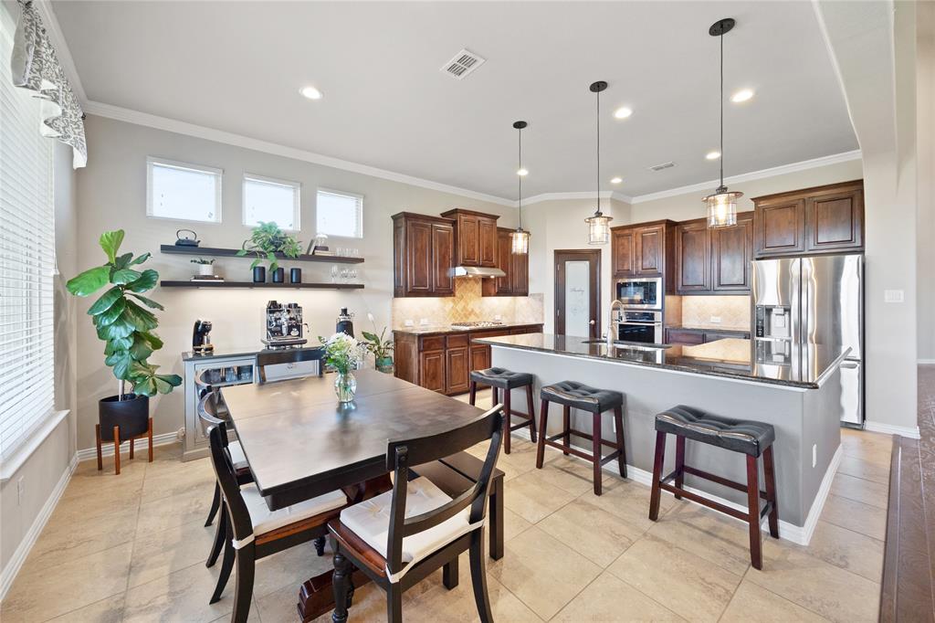 216 Equestrian Road Hickory Creek, TX 75065 - Photo 6 of 26 a view of kitchen with kitchen island dining table and chairs