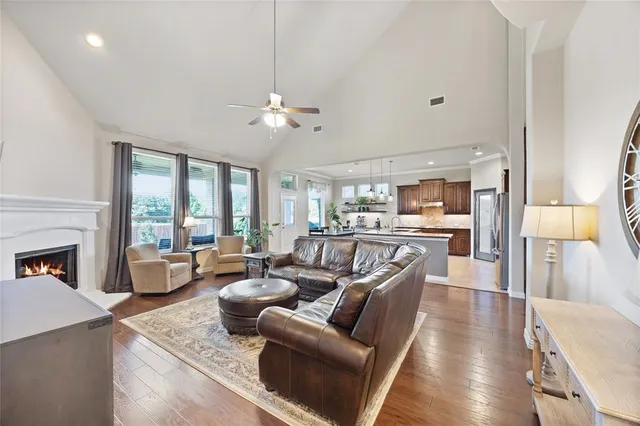 a living room with furniture fireplace and a large window