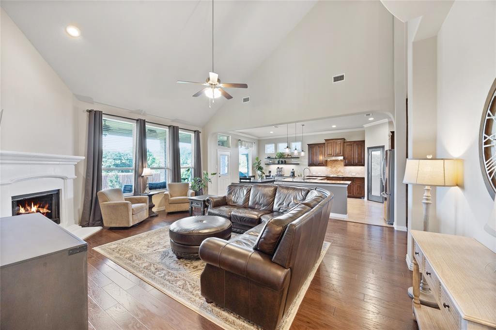216 Equestrian Road Hickory Creek, TX 75065 - Photo 10 of 26 a living room with furniture fireplace and a large window