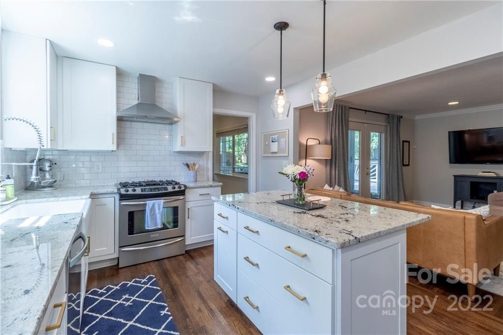 3722 Sulkirk Road Charlotte, NC 28210 - Photo 11 of 37 a kitchen with stainless steel appliances granite countertop a sink stove a refrigerator and cabinets