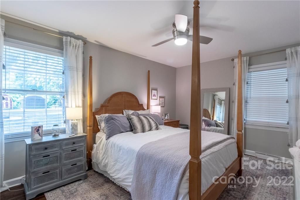 3722 Sulkirk Road Charlotte, NC 28210 - Photo 22 of 37 a bedroom with a large bed and a chandelier