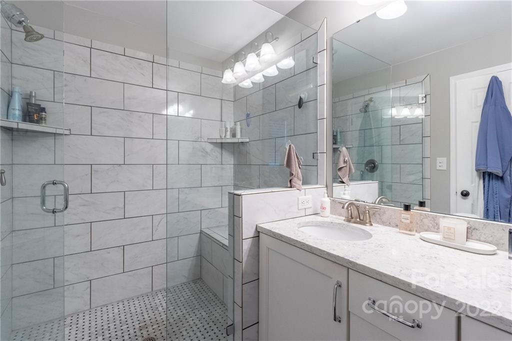 3722 Sulkirk Road Charlotte, NC 28210 - Photo 23 of 37 a bathroom with a sink shower and a mirror