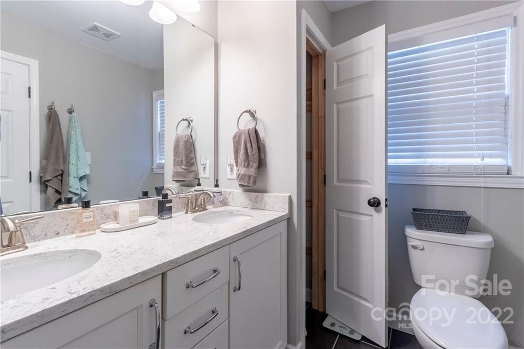 3722 Sulkirk Road Charlotte, NC 28210 - Photo 24 of 37 a bathroom with a granite countertop toilet sink and a mirror