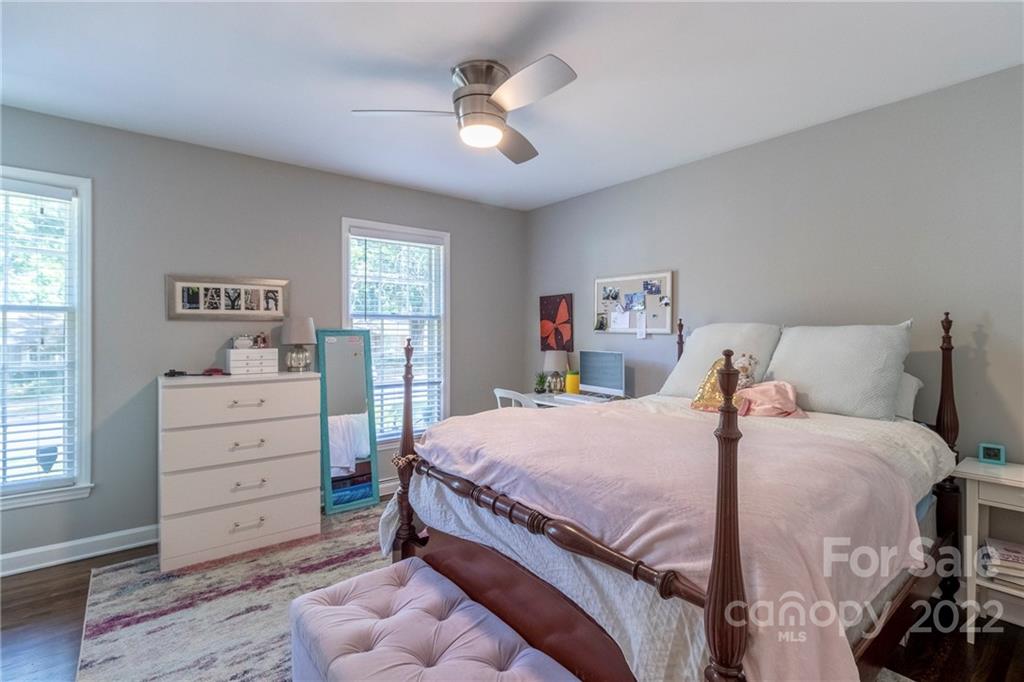 3722 Sulkirk Road Charlotte, NC 28210 - Photo 25 of 37 a bedroom with a bed and a ceiling fan