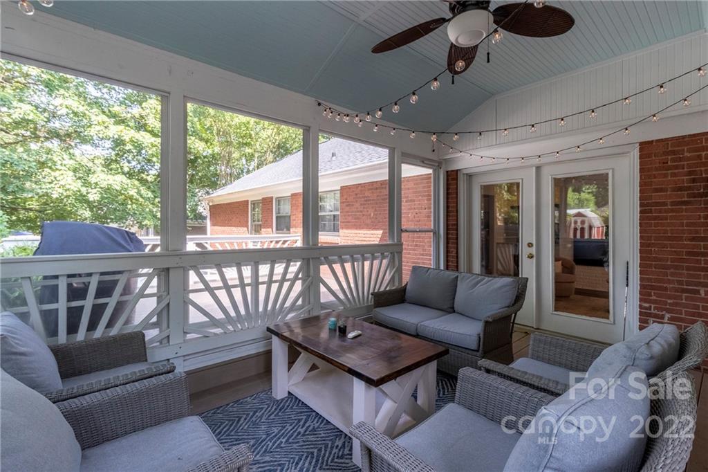 3722 Sulkirk Road Charlotte, NC 28210 - Photo 28 of 37 a living room with furniture and a floor to ceiling window