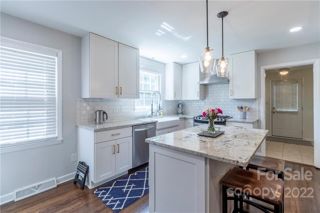 3722 Sulkirk Road Charlotte, NC 28210 - Photo 10 of 37 a kitchen with granite countertop kitchen island stainless steel appliances a sink stove and kitchen island