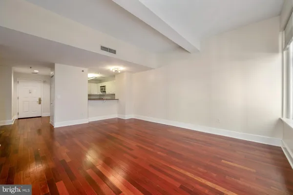 a view of an empty room and wooden floor