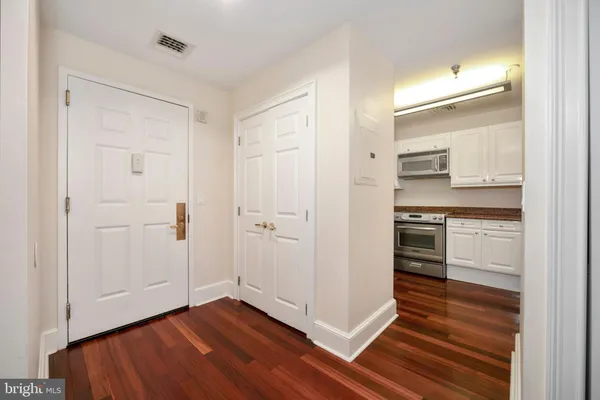 a kitchen with wooden floors and white appliances