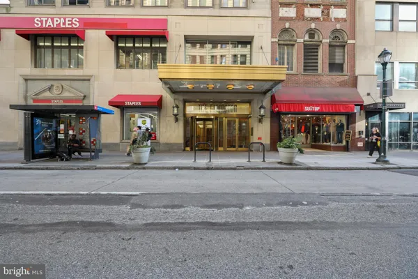 a front view of multi story commercial building with retail shops