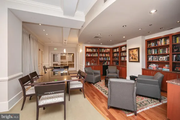 a living room with fireplace furniture and a book shelf