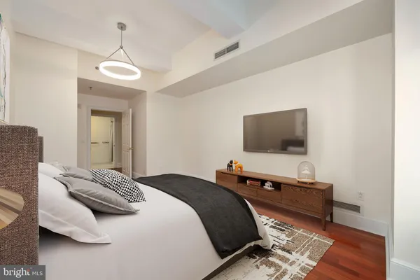 a bedroom with a bed and a flat screen tv