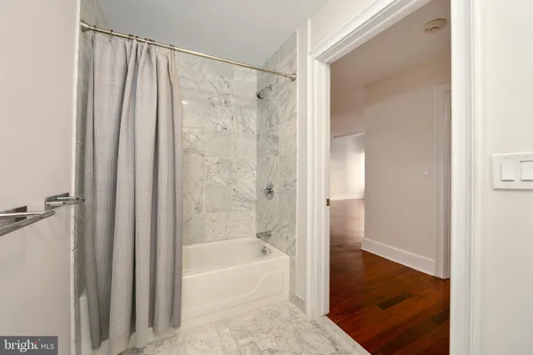 a bathroom with a shower and a bath tub
