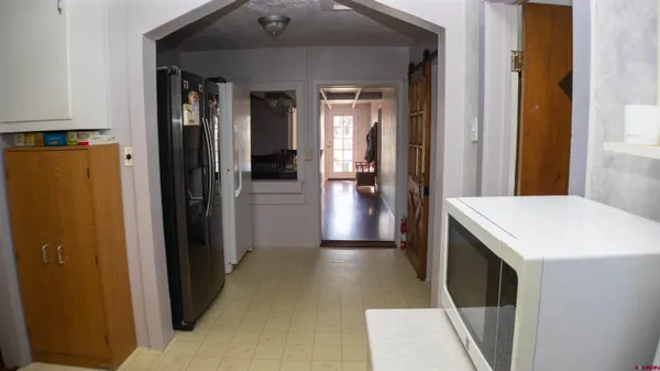 a view of a kitchen from the hallway
