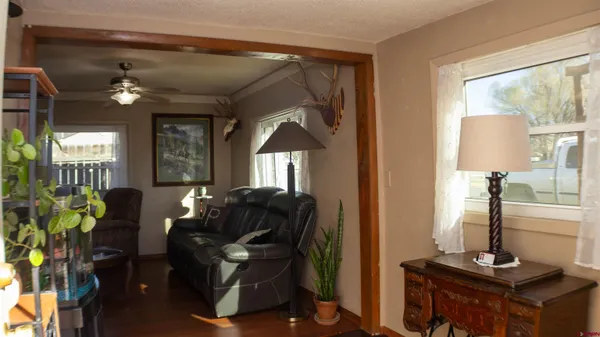 a living room with furniture a window and a chandelier