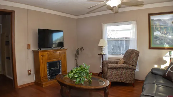 a living room with furniture a fireplace and a flat screen tv