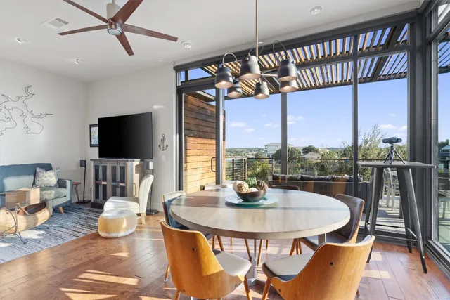 a view of a dining room with furniture a chandelier and wooden floor