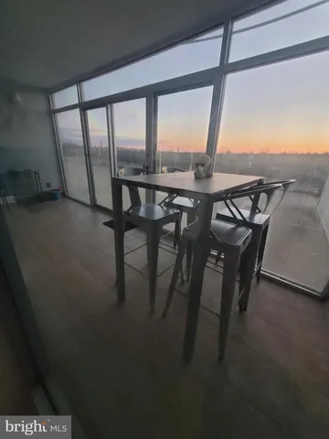 a view of a room with furniture and floor to ceiling window