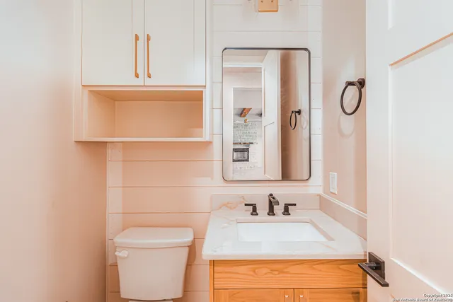 a bathroom with a double vanity sink and mirror