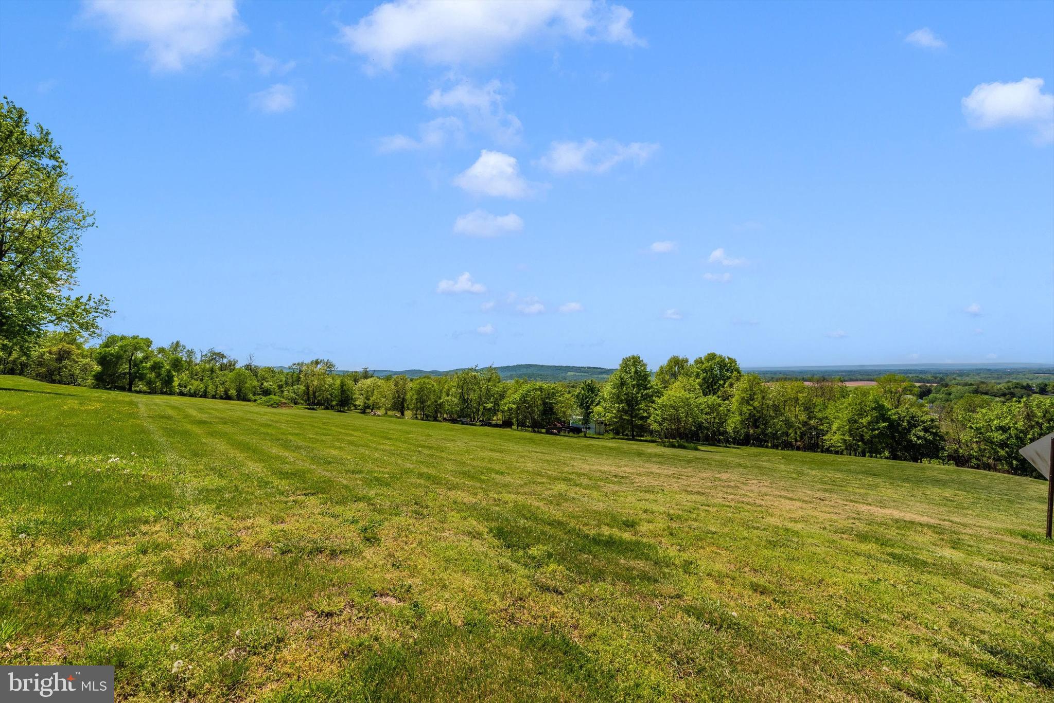 56 Clevelandtown-netz Road Boonsboro, MD 21713 - Photo 15 of 20 a view of a grassy field with an trees
