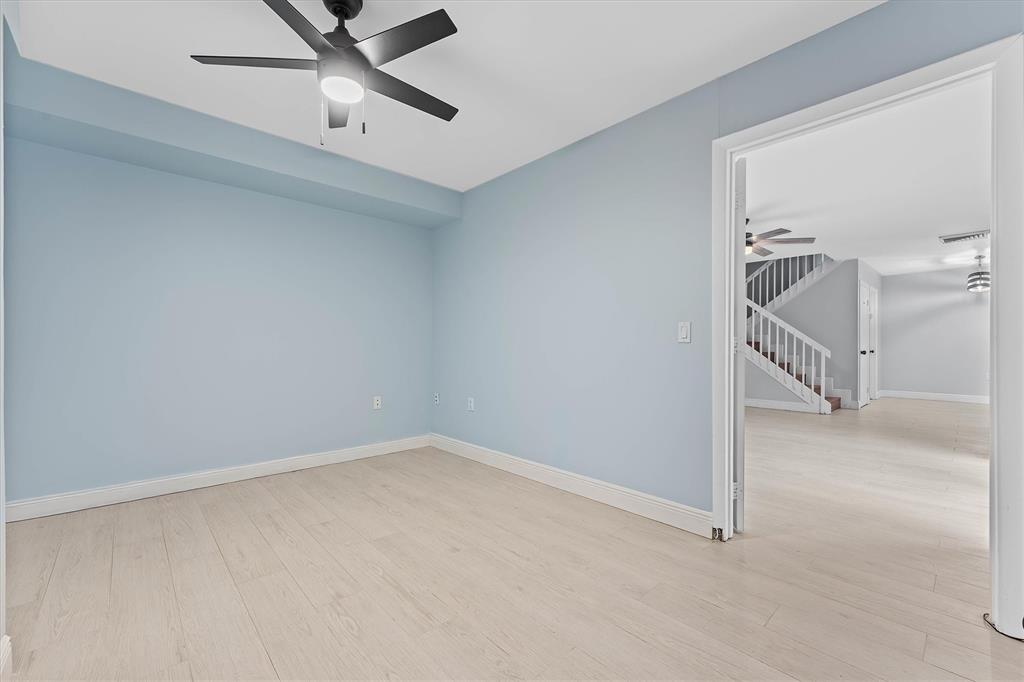 9156 Southwest 23rd Street, Unit D Davie, FL 33324 - Photo 15 of 35 an empty room with a ceiling fan and stairs