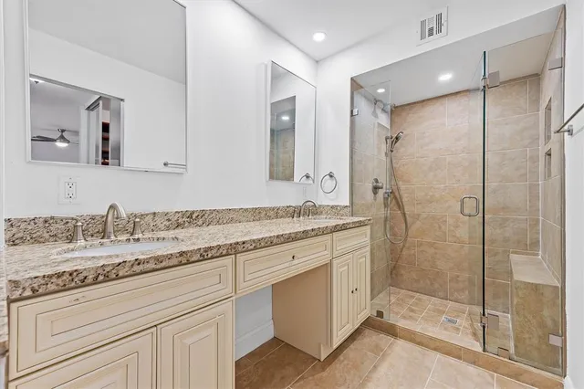 a bathroom with a granite countertop sink mirror and double