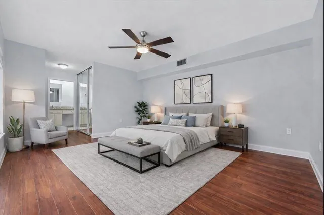 a spacious bedroom with a bed couch and a window