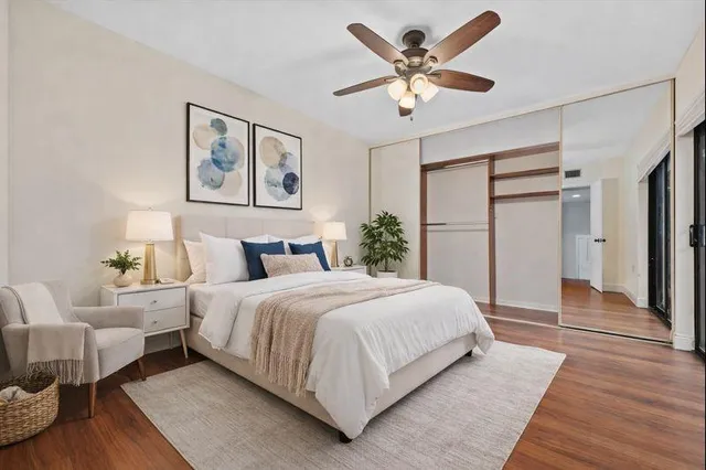 a bedroom with a large bed and a chandelier