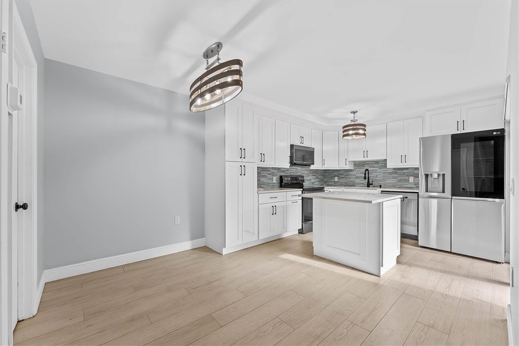 9156 Southwest 23rd Street, Unit D Davie, FL 33324 - Photo 9 of 35 a kitchen with cabinets stainless steel appliances and a window