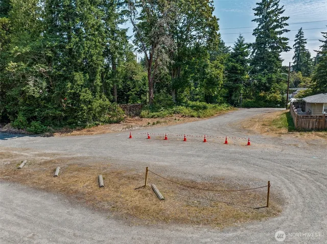 a white house that has a tree on the side of it