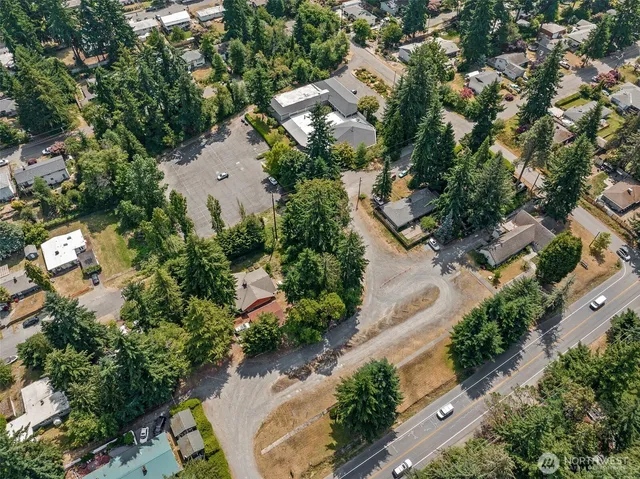 an aerial view of a house with a yard and lake view