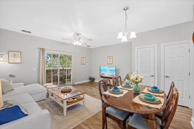 a living room with furniture a chandelier and a table