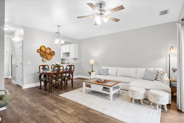 a living room with furniture and kitchen view