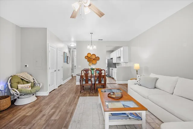 a living room with furniture and wooden floor