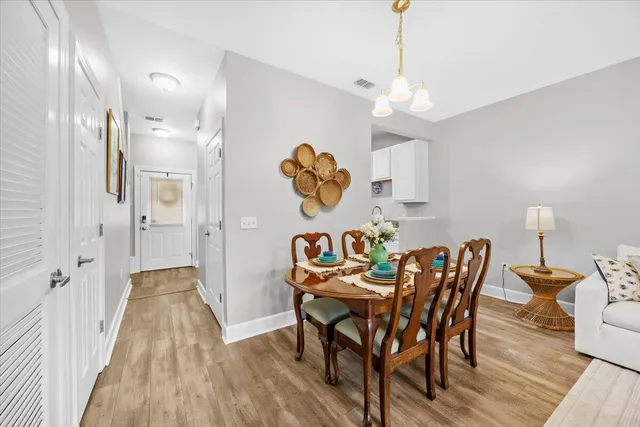 a view of a dining room with furniture wooden floor and chandelier