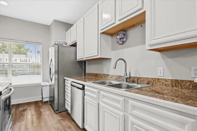 a kitchen with stainless steel appliances granite countertop a sink and a stove