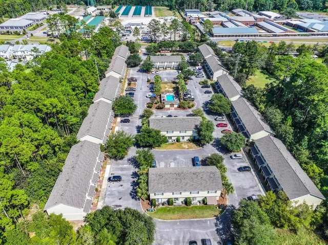 an aerial view of residential houses with outdoor space