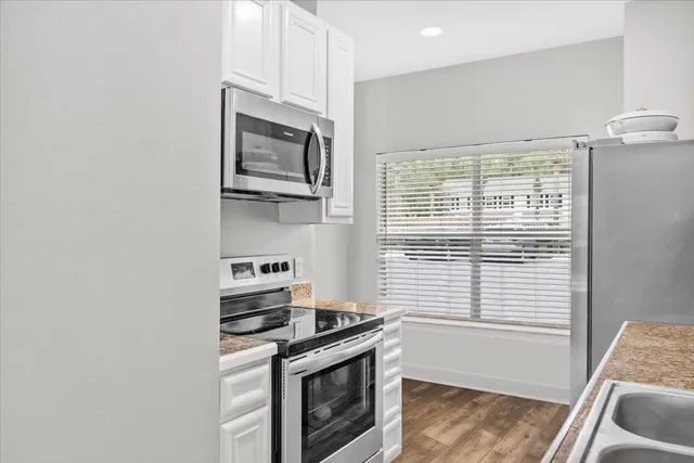 a kitchen with stainless steel appliances a stove and a microwave