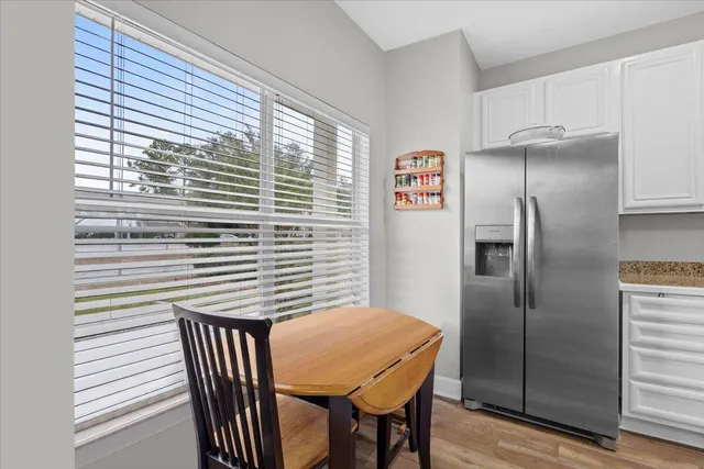 a kitchen with a table and refrigerator