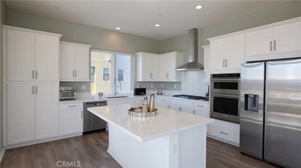 201 Merit Irvine, CA 92618 - Photo 3 of 8 a kitchen with stainless steel appliances a sink a stove a refrigerator and cabinets