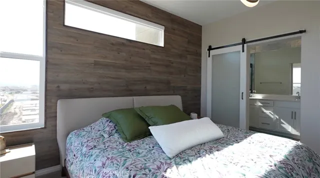 a bedroom with a bed window and walk in closet