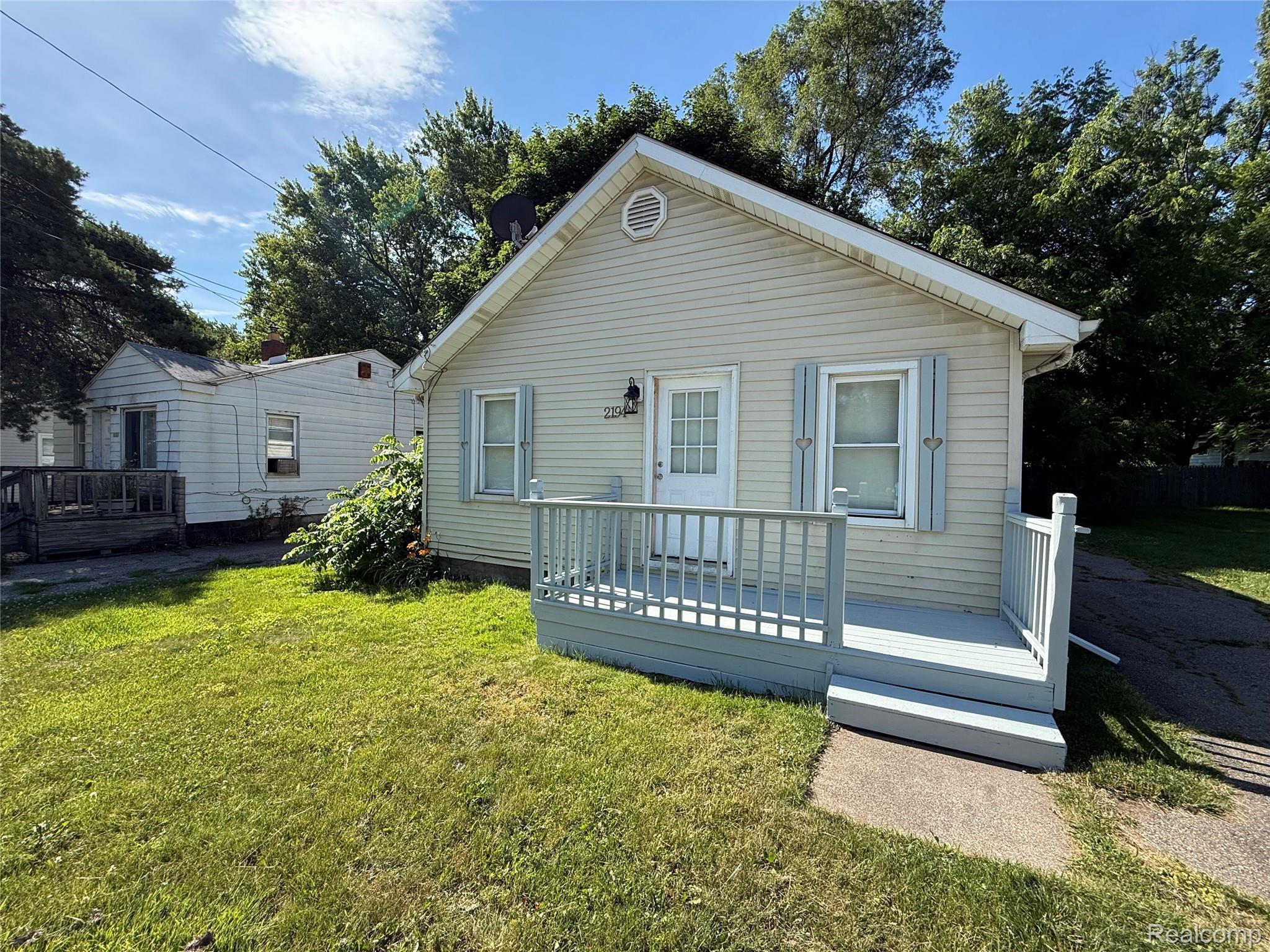 2194 East Bristol Road Burton, MI 48529 - Photo 2 of 6 Single-story residence featuring light-colored siding and a gabled roofline