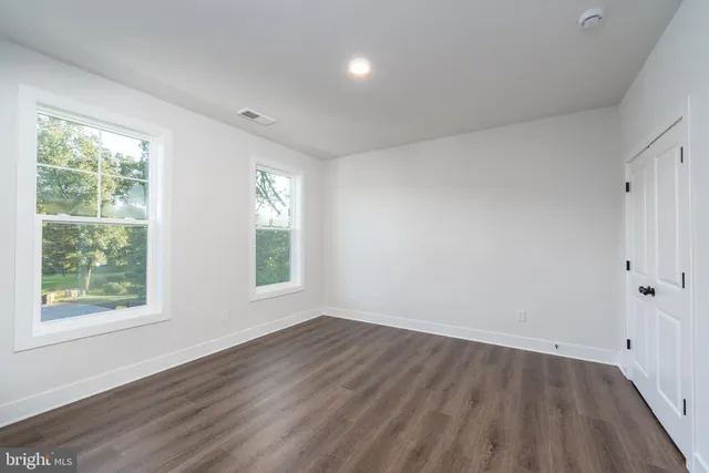 a view of a room with wooden floor