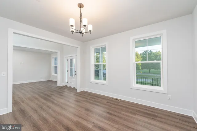 a kitchen with stainless steel appliances kitchen island granite countertop a stove a sink and a refrigerator