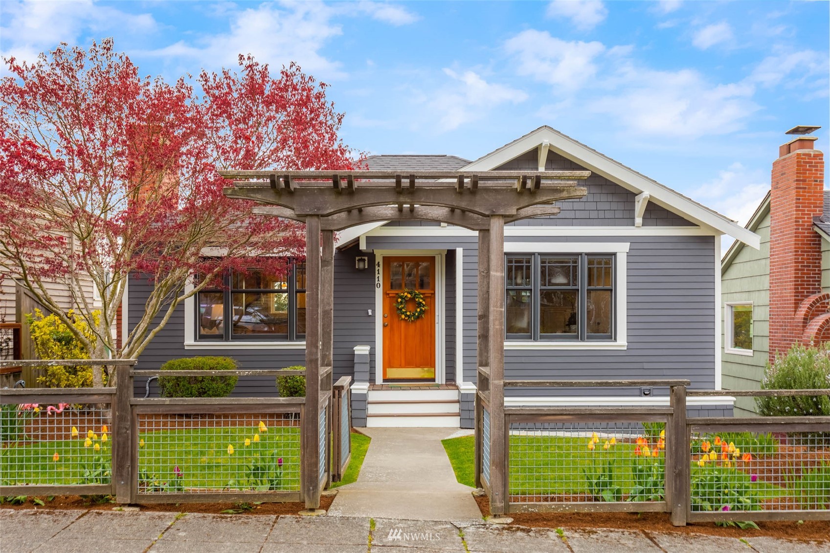 4110 38th Avenue Southwest Seattle, WA 98126 - Photo 1 of 29 a front view of a house with a garden and plants