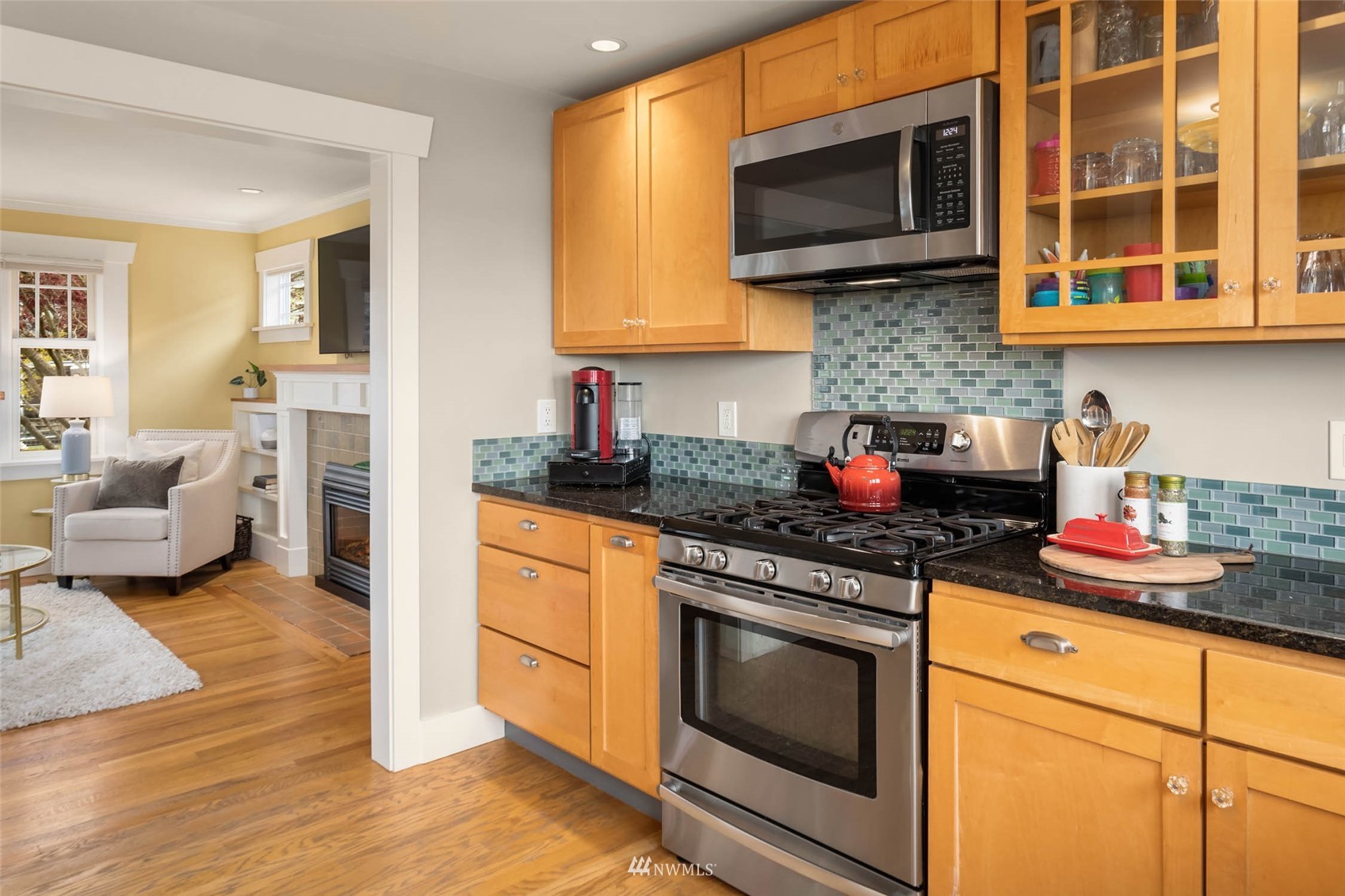 4110 38th Avenue Southwest Seattle, WA 98126 - Photo 13 of 29 a kitchen with stainless steel appliances granite countertop a stove microwave and cabinets