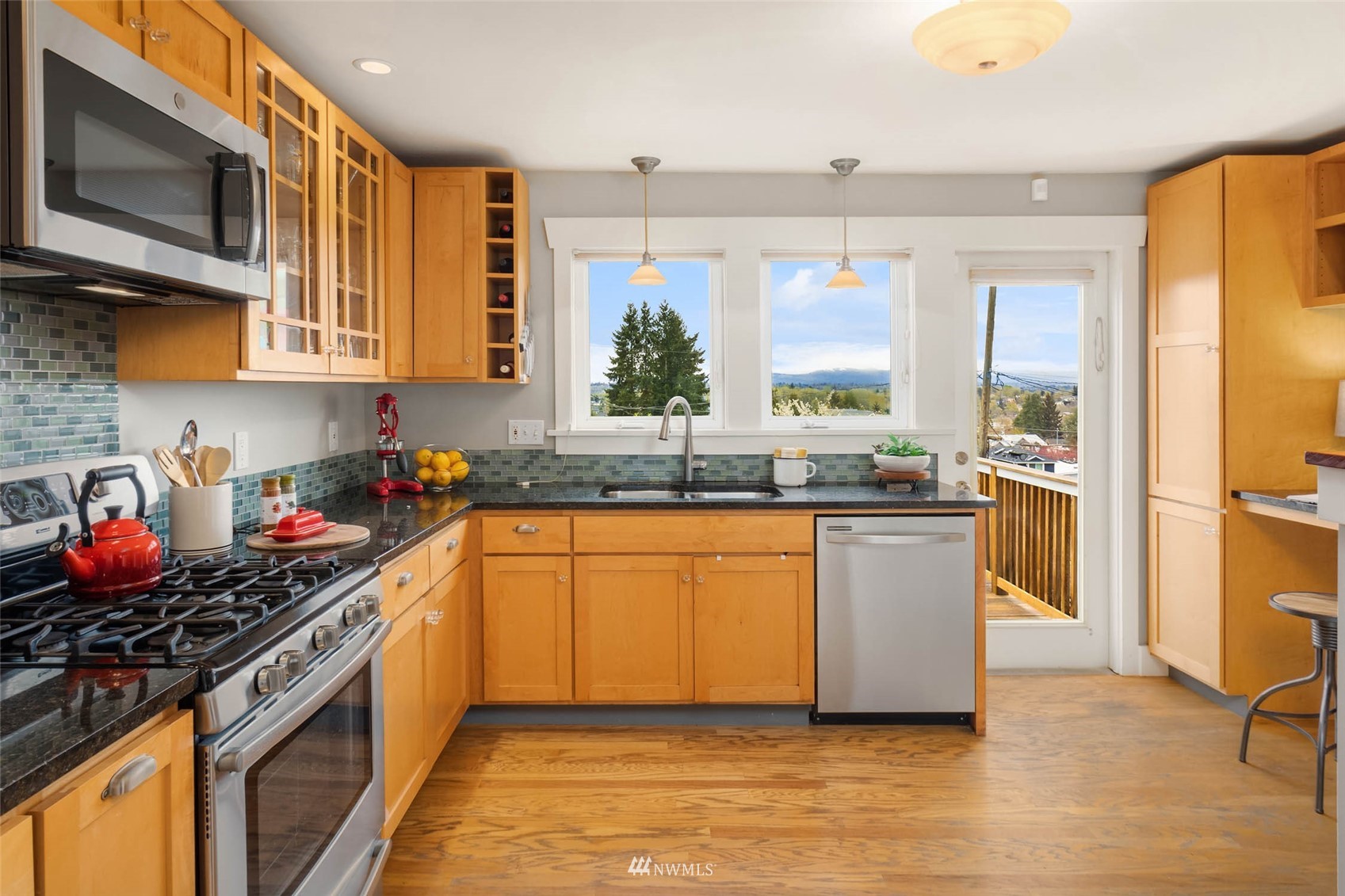 4110 38th Avenue Southwest Seattle, WA 98126 - Photo 14 of 29 a kitchen with stainless steel appliances granite countertop a stove a sink and a refrigerator