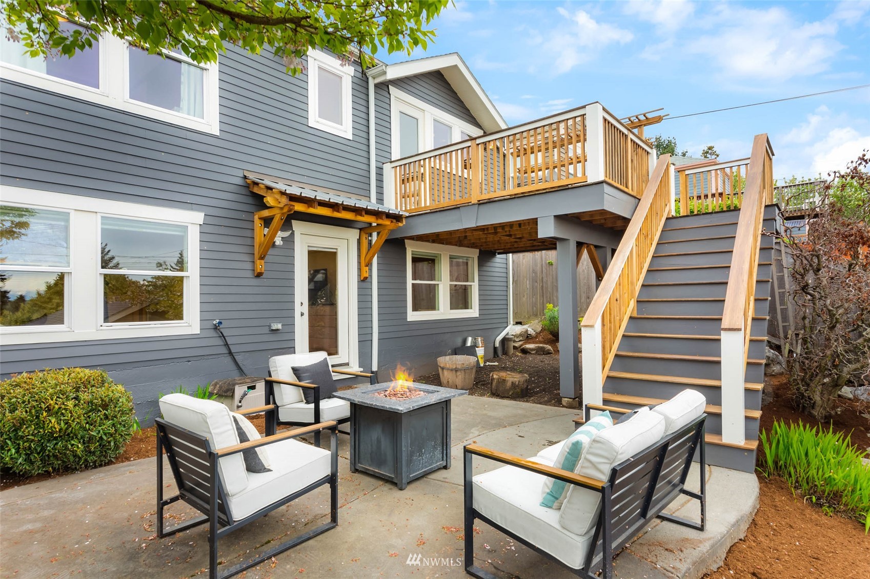 4110 38th Avenue Southwest Seattle, WA 98126 - Photo 17 of 29 a view of a patio with couches table and chairs with wooden floor and fence