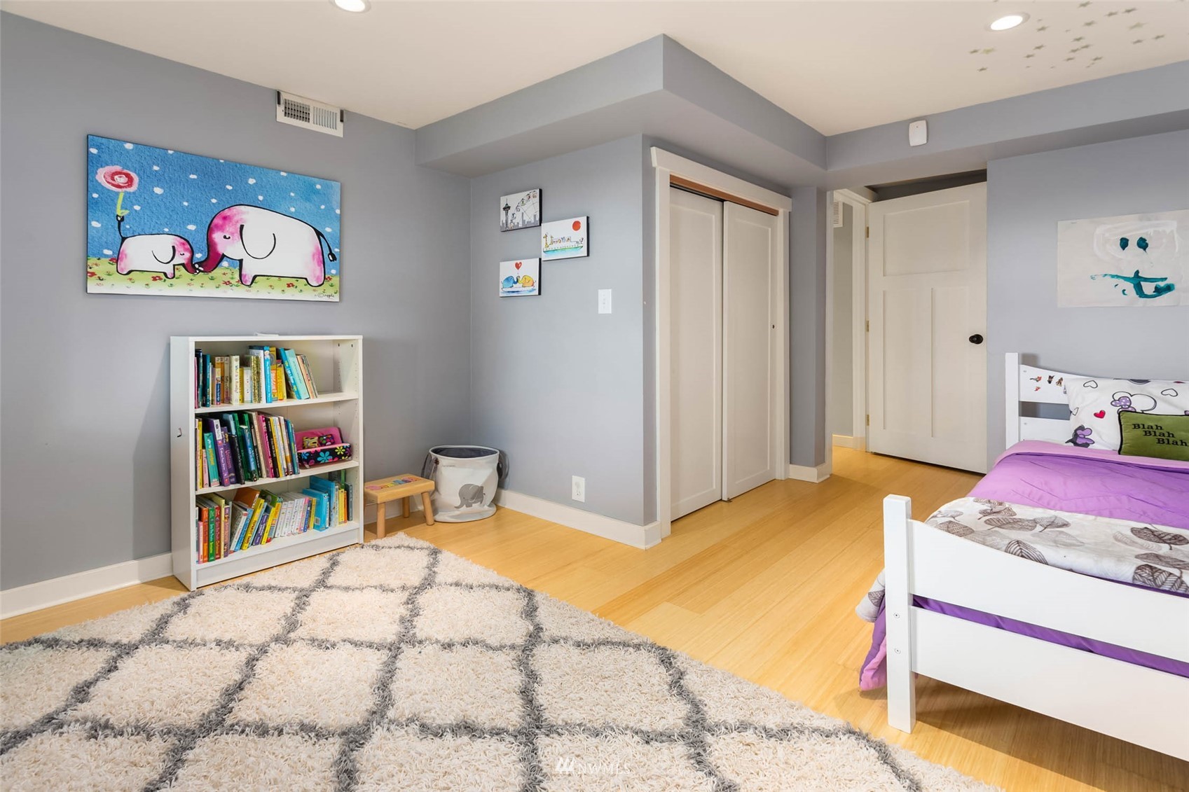 4110 38th Avenue Southwest Seattle, WA 98126 - Photo 24 of 29 a bedroom with a bed and book shelf