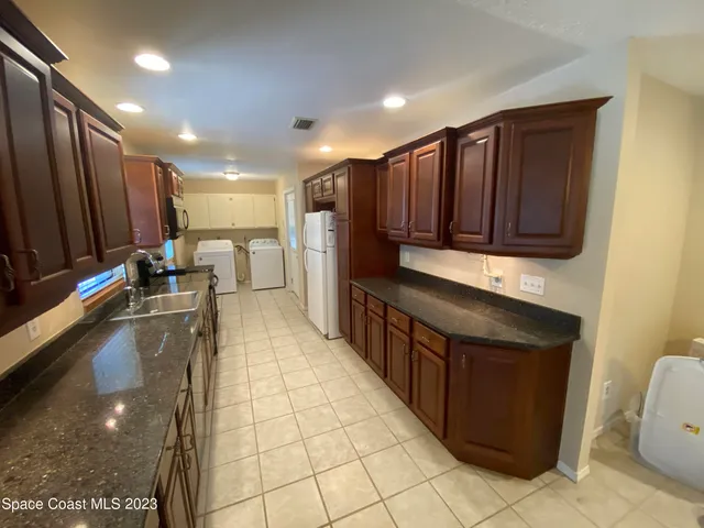 a kitchen with stainless steel appliances a stove a sink and a microwave